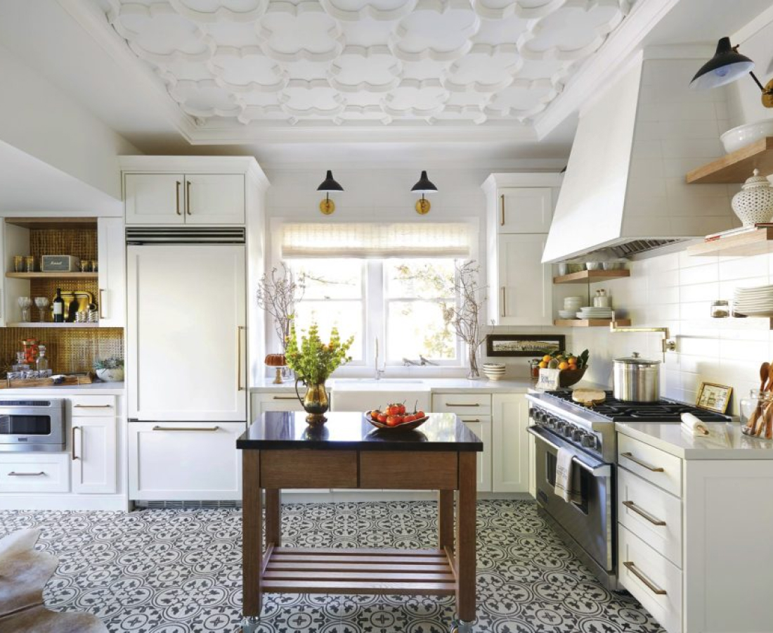Bright modern kitchen with white cabinetry and central island.