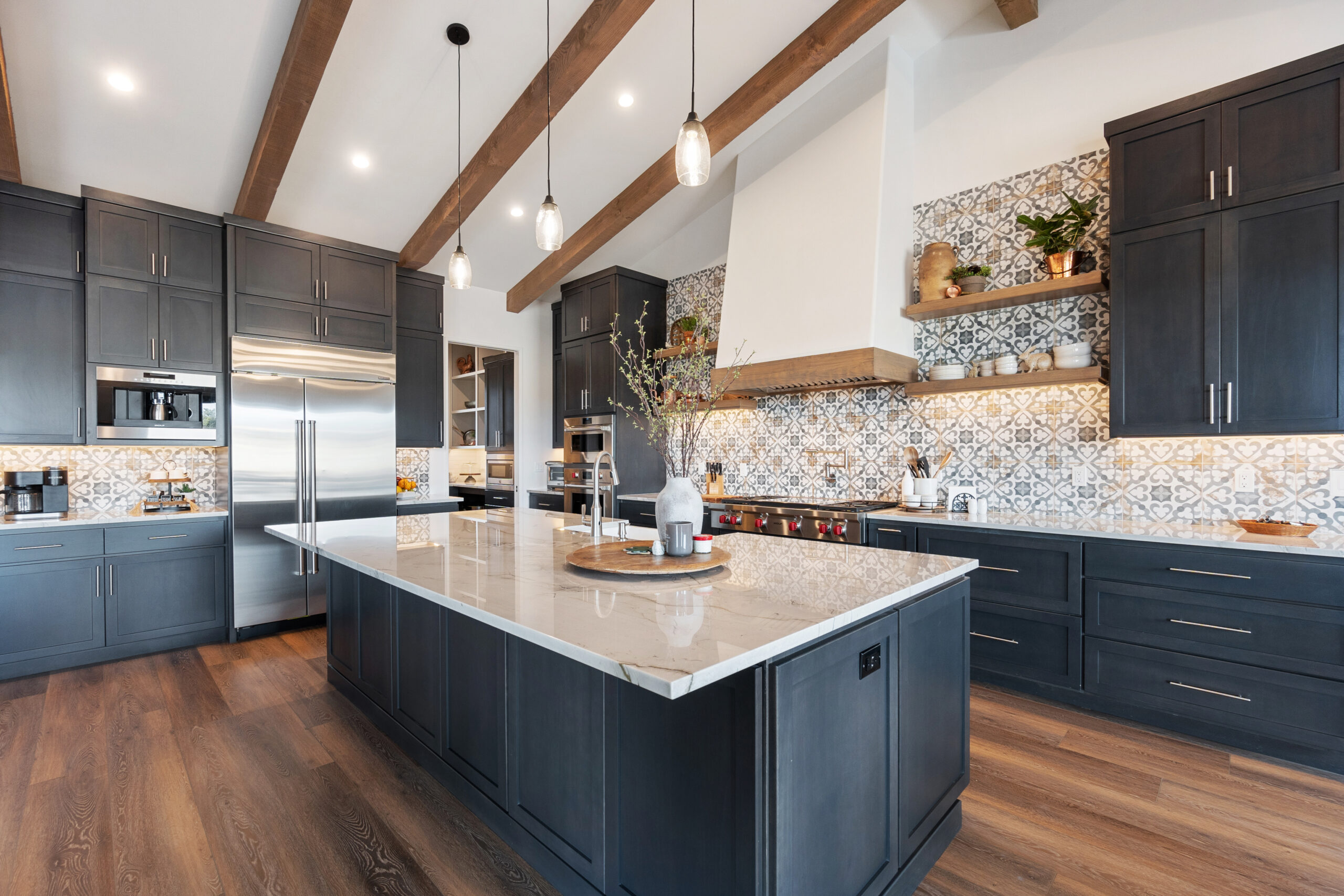 Modern kitchen with a spacious island and mosaic backsplash.