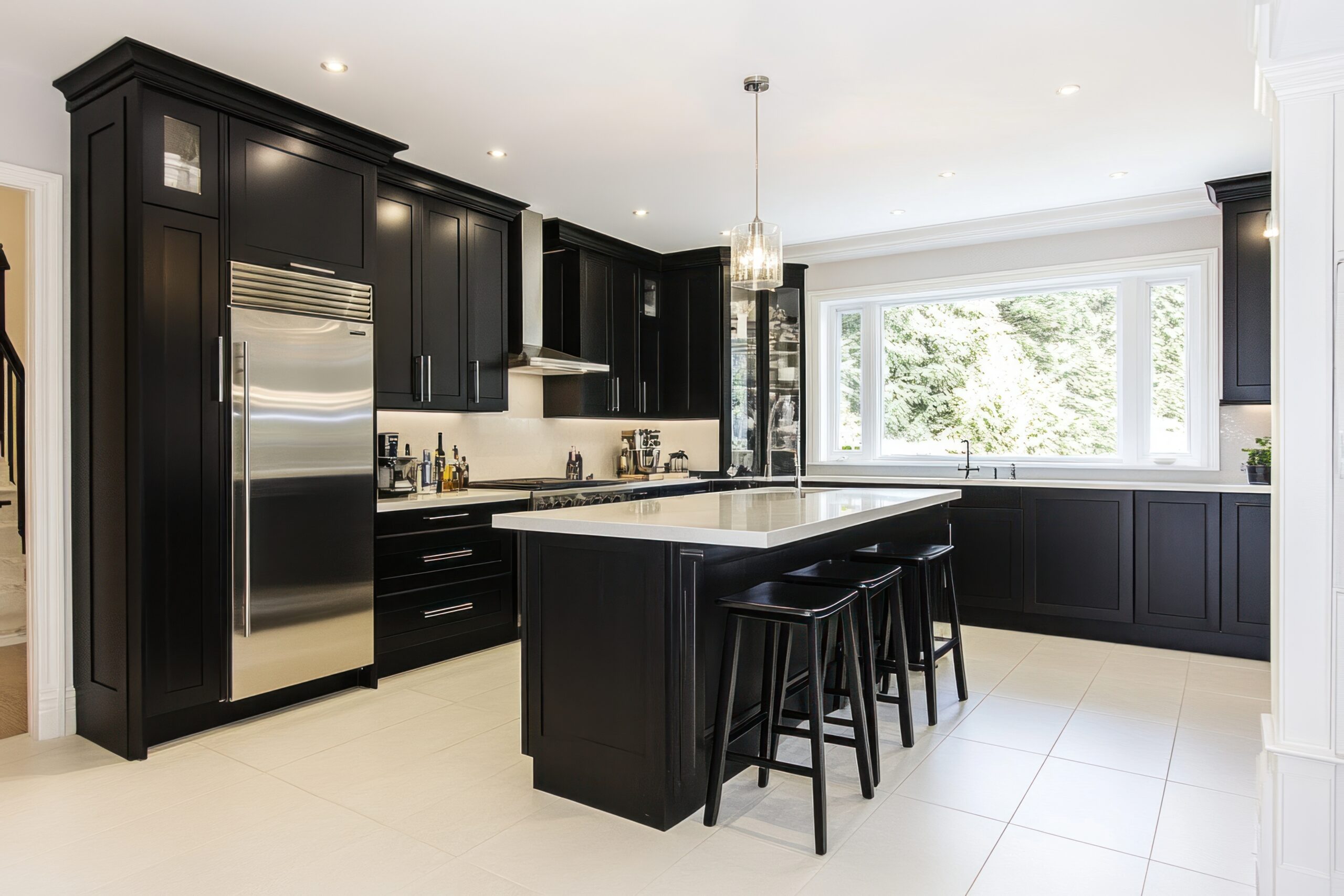 Modern black and white kitchen with island and stools.